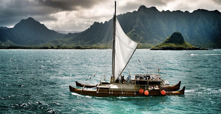 The Polynesian Cultural Center sails the Iosepa, BYU–Hawaii's 57-foot wa'a kaulua or traditional Hawaiian canoe, past Mokoli'i islet in Kaneohe Bay.